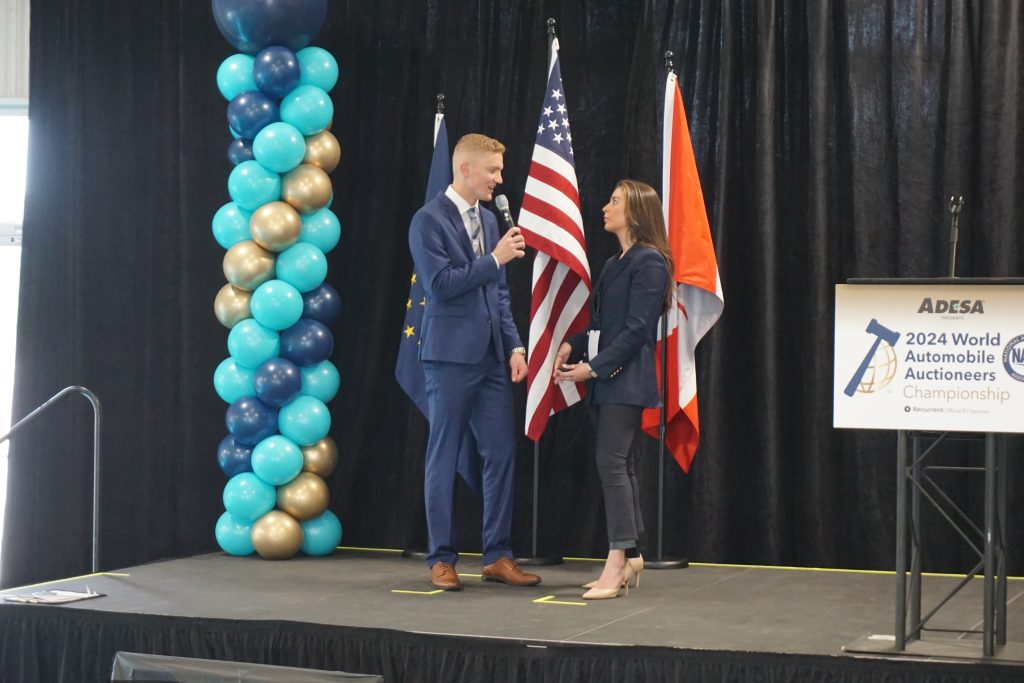 An MC interviewing a competitor